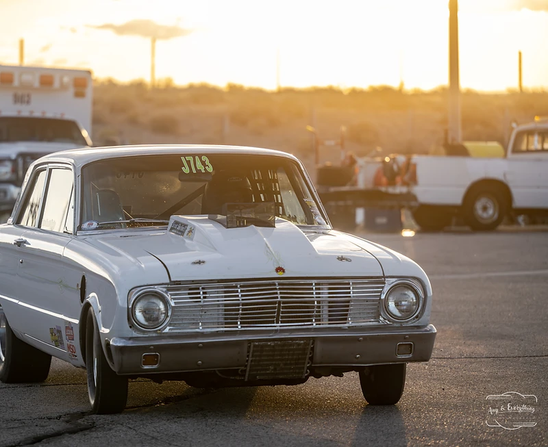 Race car silhouetted against a Fallon sunset at Top Gun Dragstrip