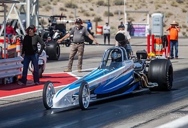 Blue junior dragster staged on the starting line at Top Gun Dragstrip