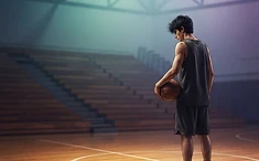 A solitary basketball player standing alone on an indoor court, head tilted down in quiet reflection.