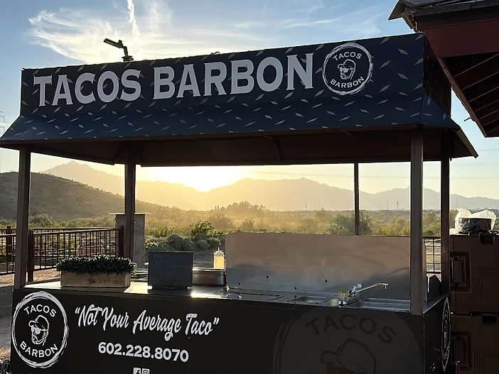 Tacos Barbon mobile catering trailer at sunset
