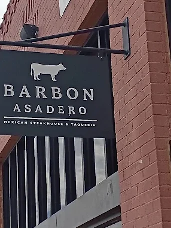 Barbon Asadero blade signage mounted on the brick exterior