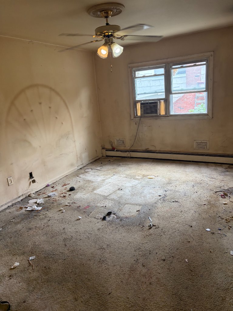 Same bedroom completely emptied down to bare walls and floor after a full clean out by Apex Property Services