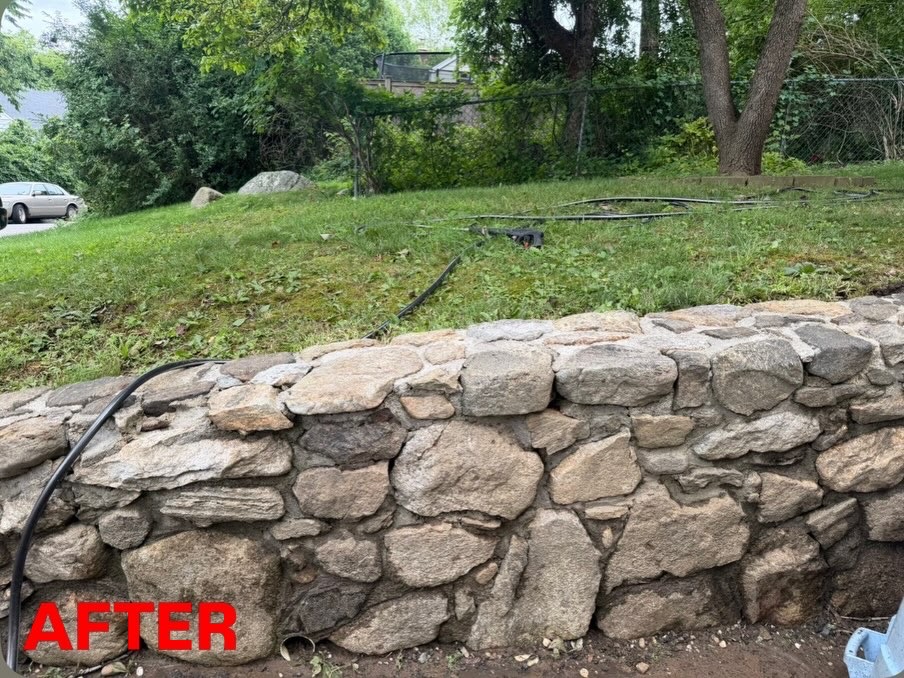 Same stone retaining wall clean and restored after power washing by Apex Property Services