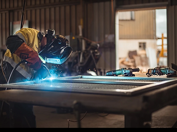 Welder at work on the fabrication floor — The Macfab Group