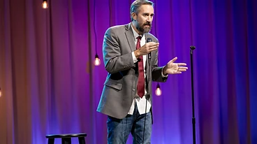 Comedian performing on stage at Comedy South