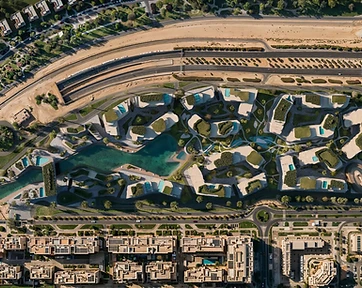 Top-down site plan of the Wadi development on Yas Island with an organic turquoise lagoon, curved residential blocks with terrace pools, and dense landscaped green spaces