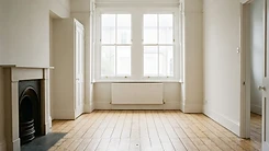 A clean empty unfurnished British living room