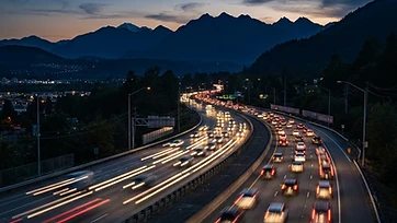Flatbed tow truck on a Fraser Valley highway at dusk