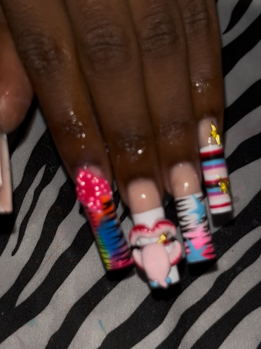 Bold freestyle set with a 3D sculpted mouth, tie-dye zebra, star charms, and striped accent nails.