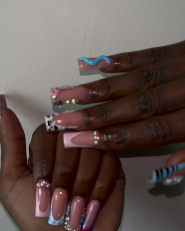 Medium-long square French tips featuring cow print, light blue swirls, and rhinestone clusters.