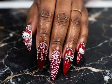 Dramatic stiletto set with 3D charms, silver micro-beads, and snowflake detailing on a dark marble canvas.