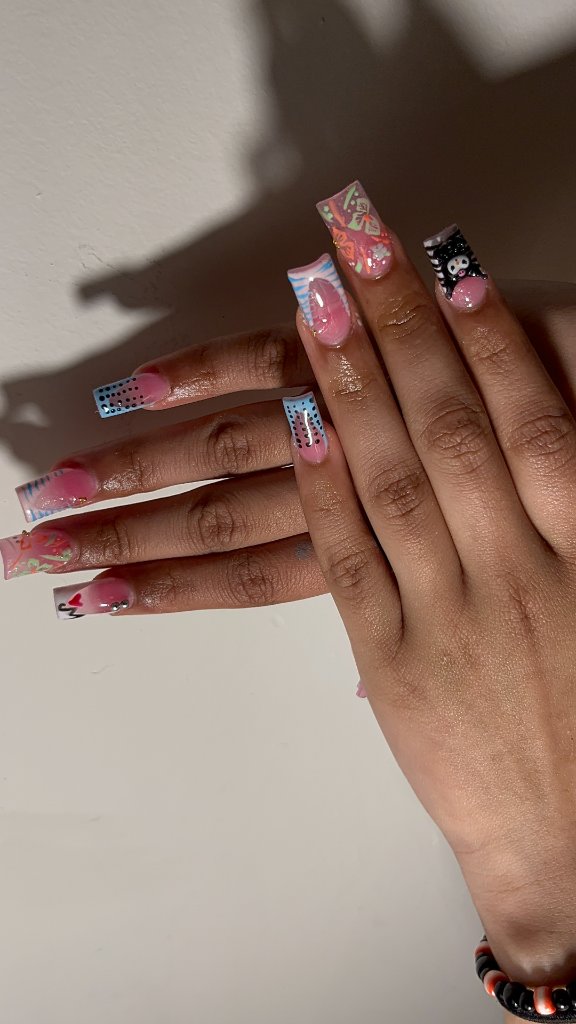 Hands with nude glossy nails being moisturized with cuticle oil