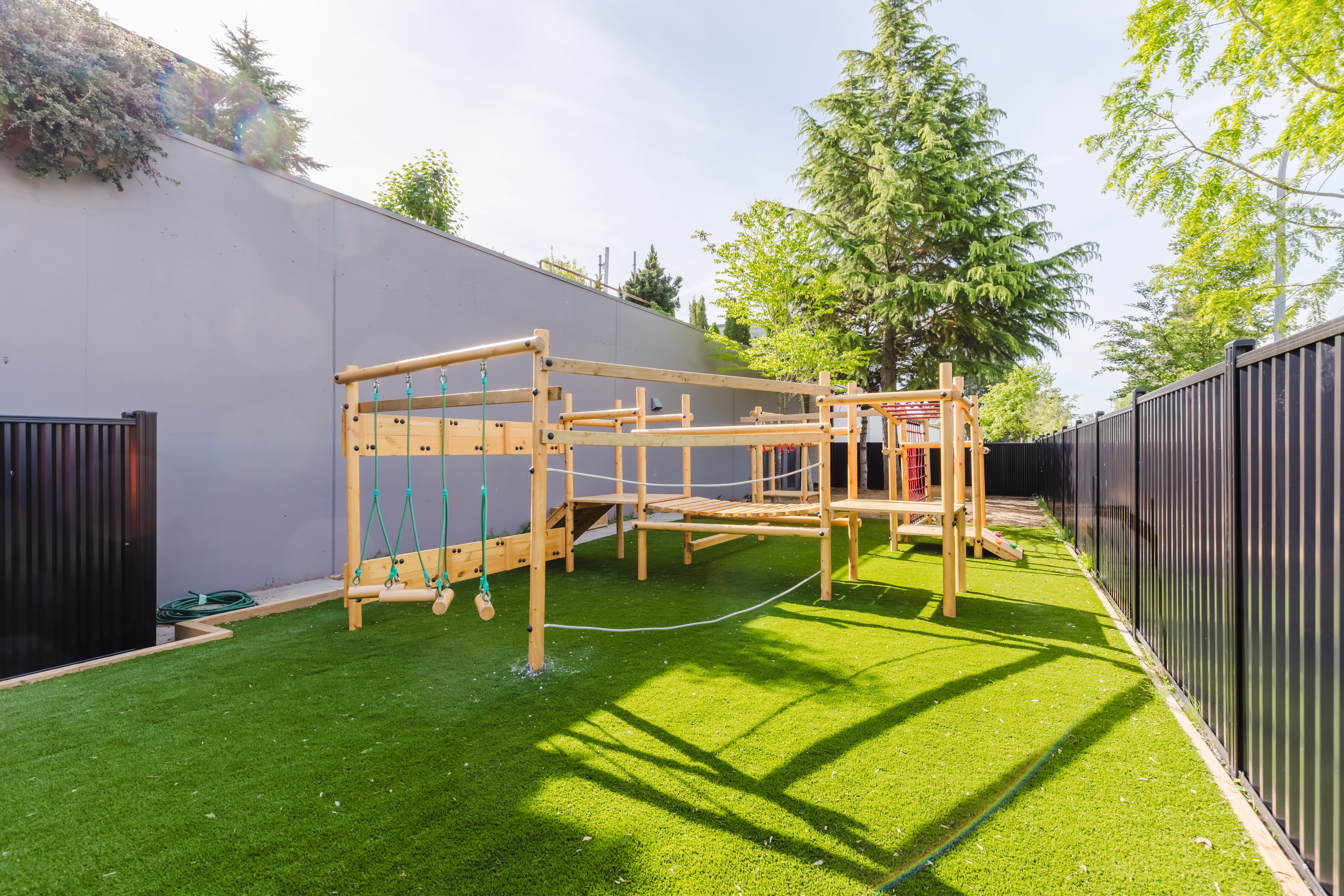 Outdoor adventure playground with swings and climbing structure at Kidzville