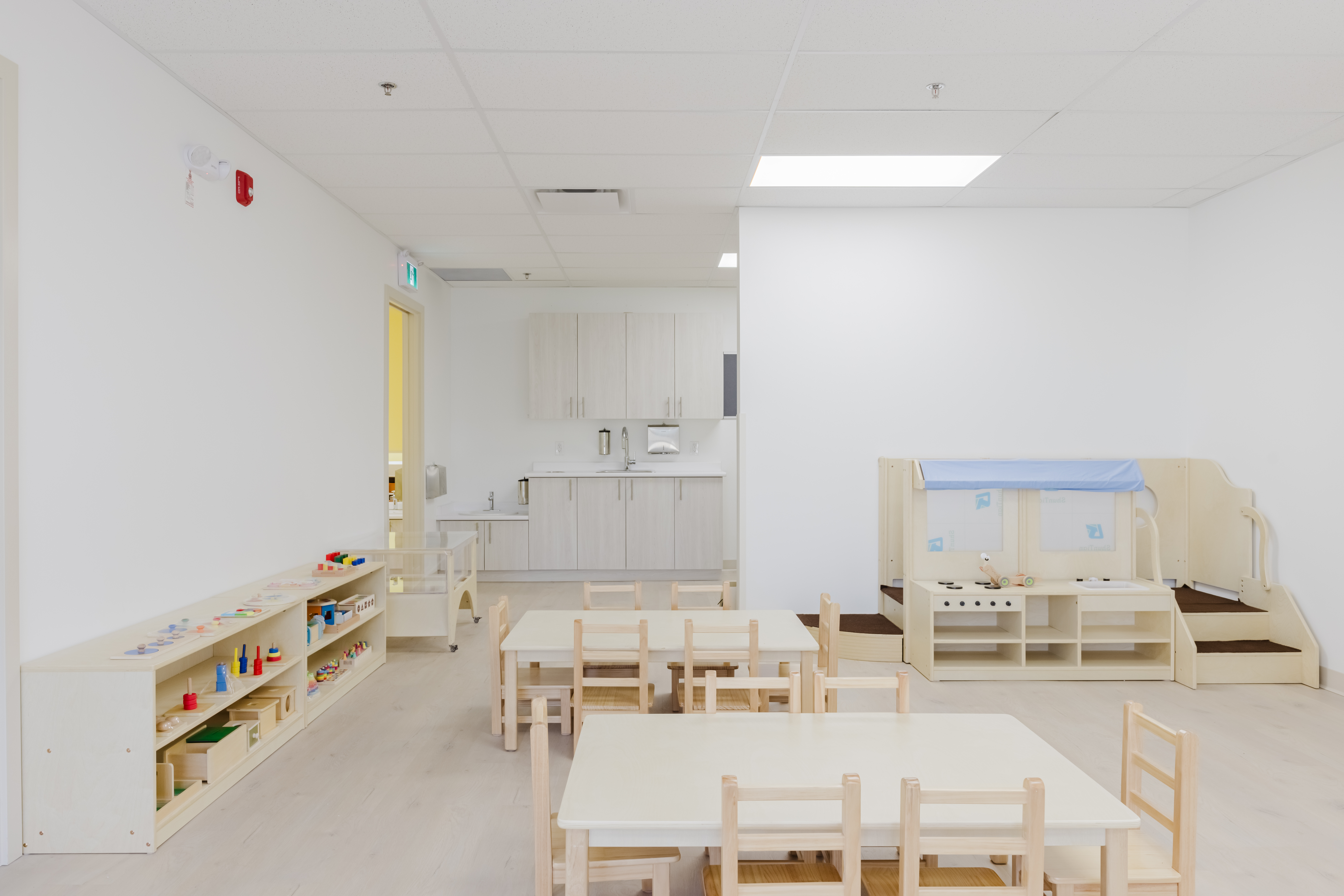Infant Nido room with reading area and learning materials at Kidzville