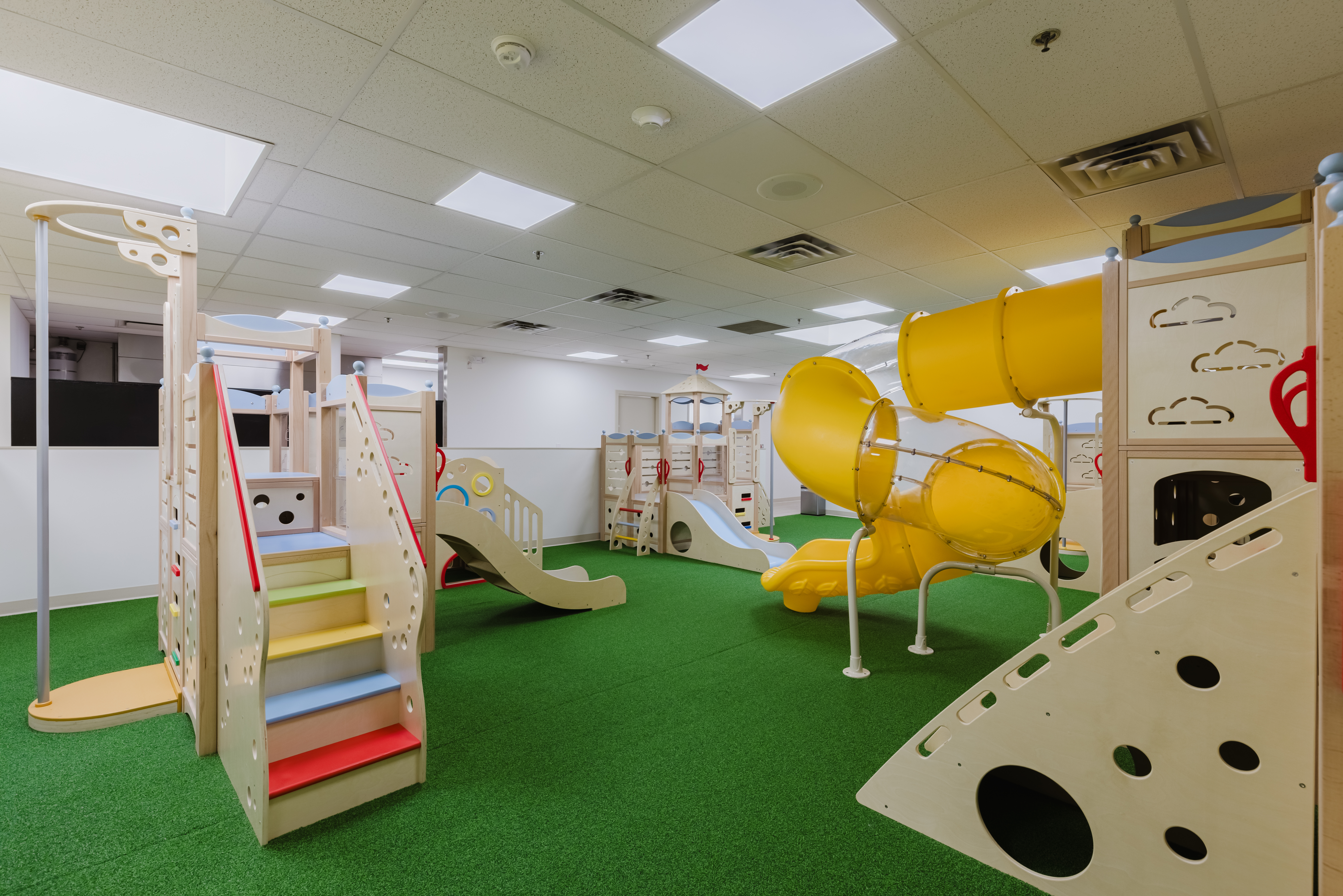 Large indoor play gym with slides and climbing structures at Kidzville
