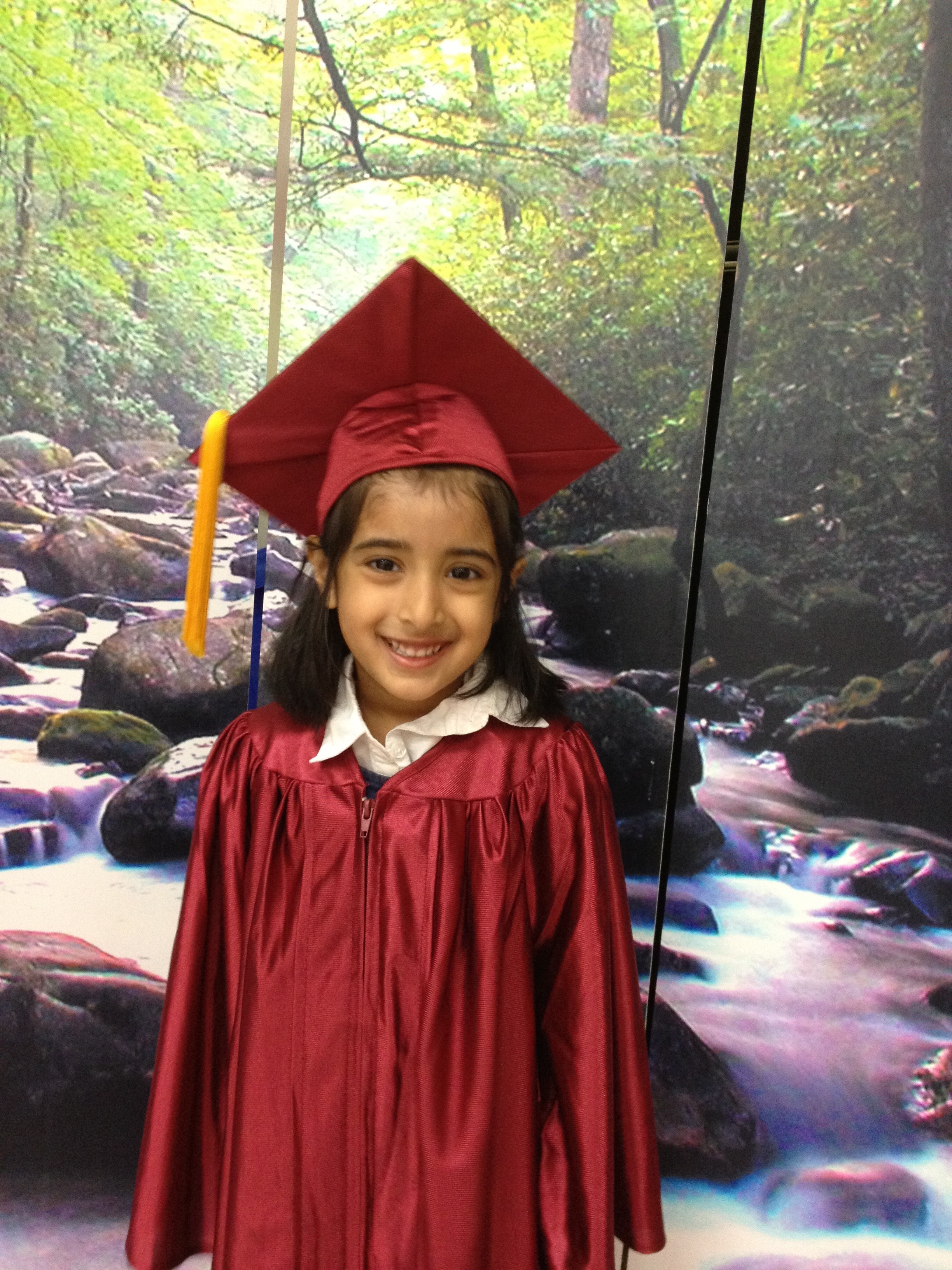 Child in graduation cap and gown at Kidzville Learning Centre ceremony