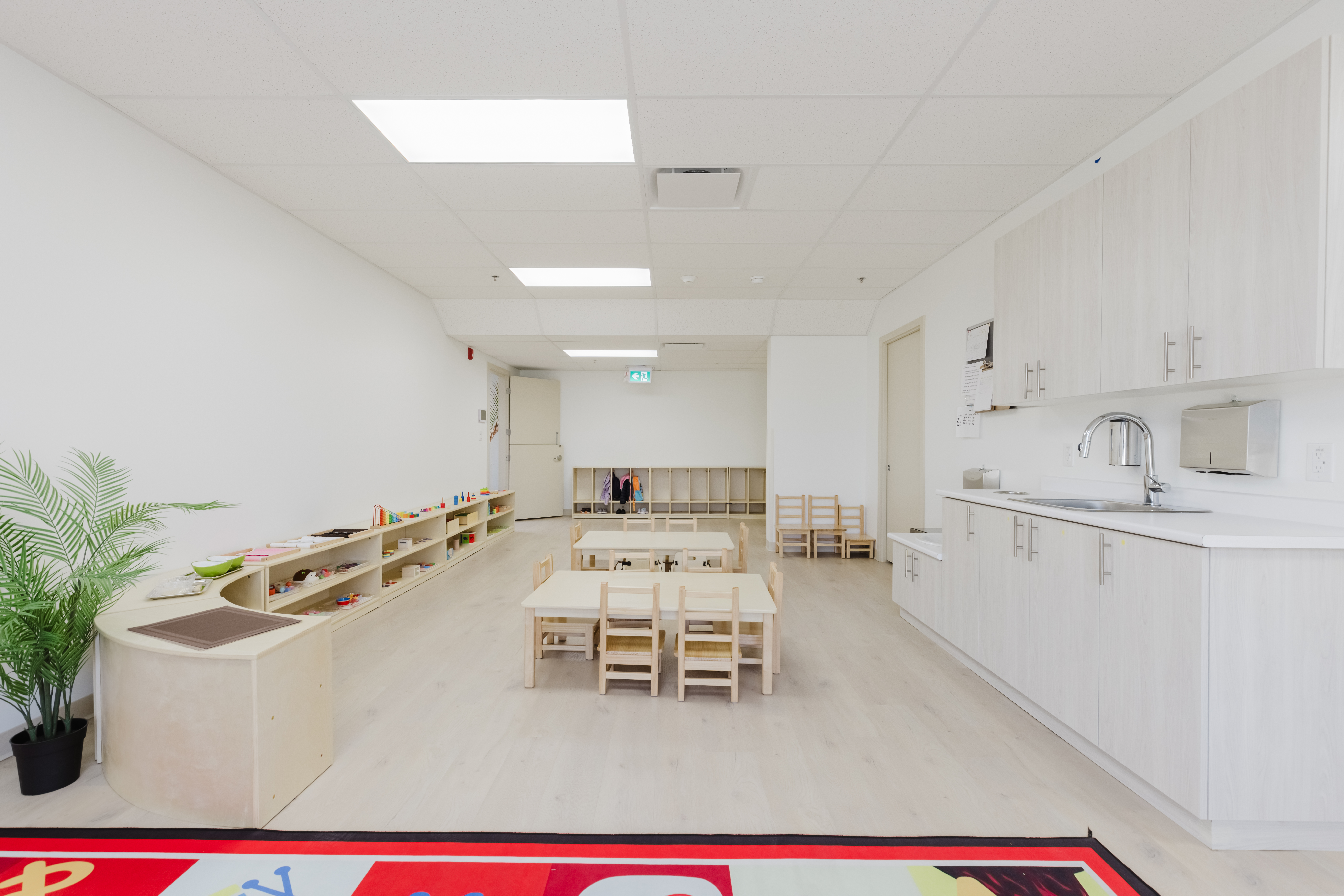 Open infant classroom with natural light and learning shelves at Kidzville
