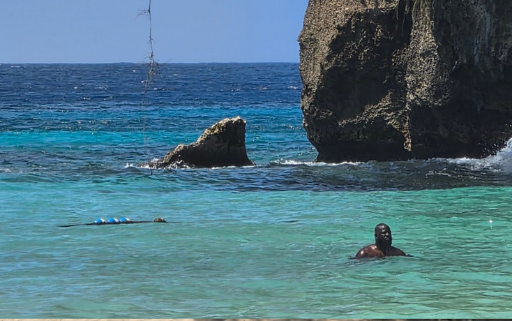 Traveler in turquoise coastal water