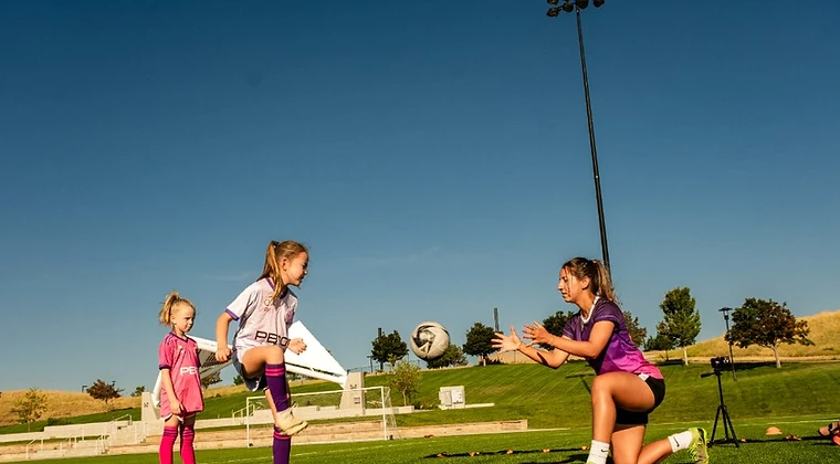 Female soccer athlete training on the field