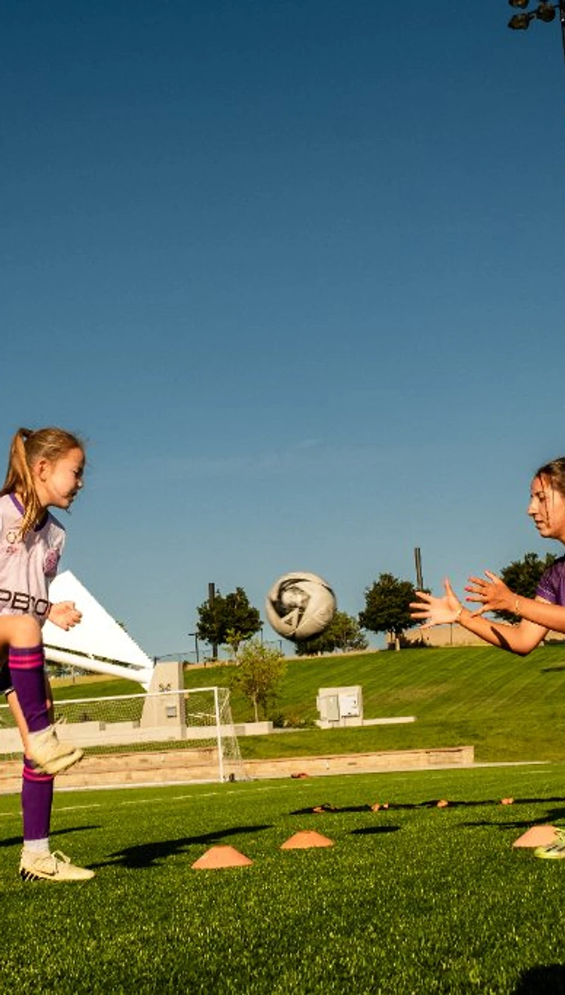 Female soccer athletes training on the field