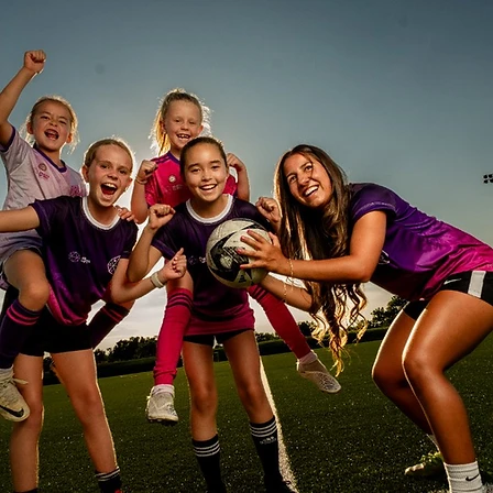 Young female soccer player training on the field