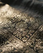 Gold zari thread woven into dark silk, close detail