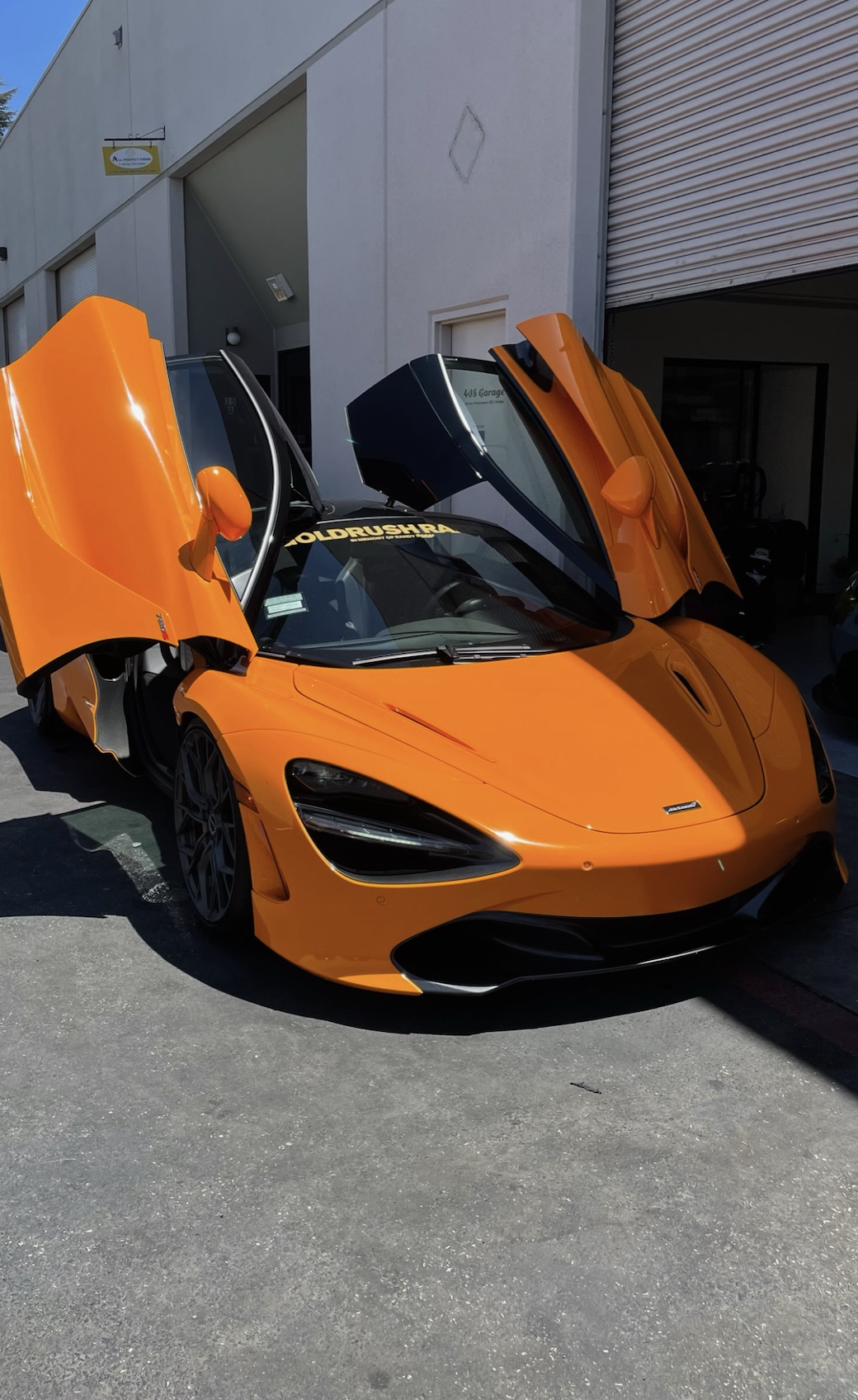 Orange McLaren 720S with doors open
