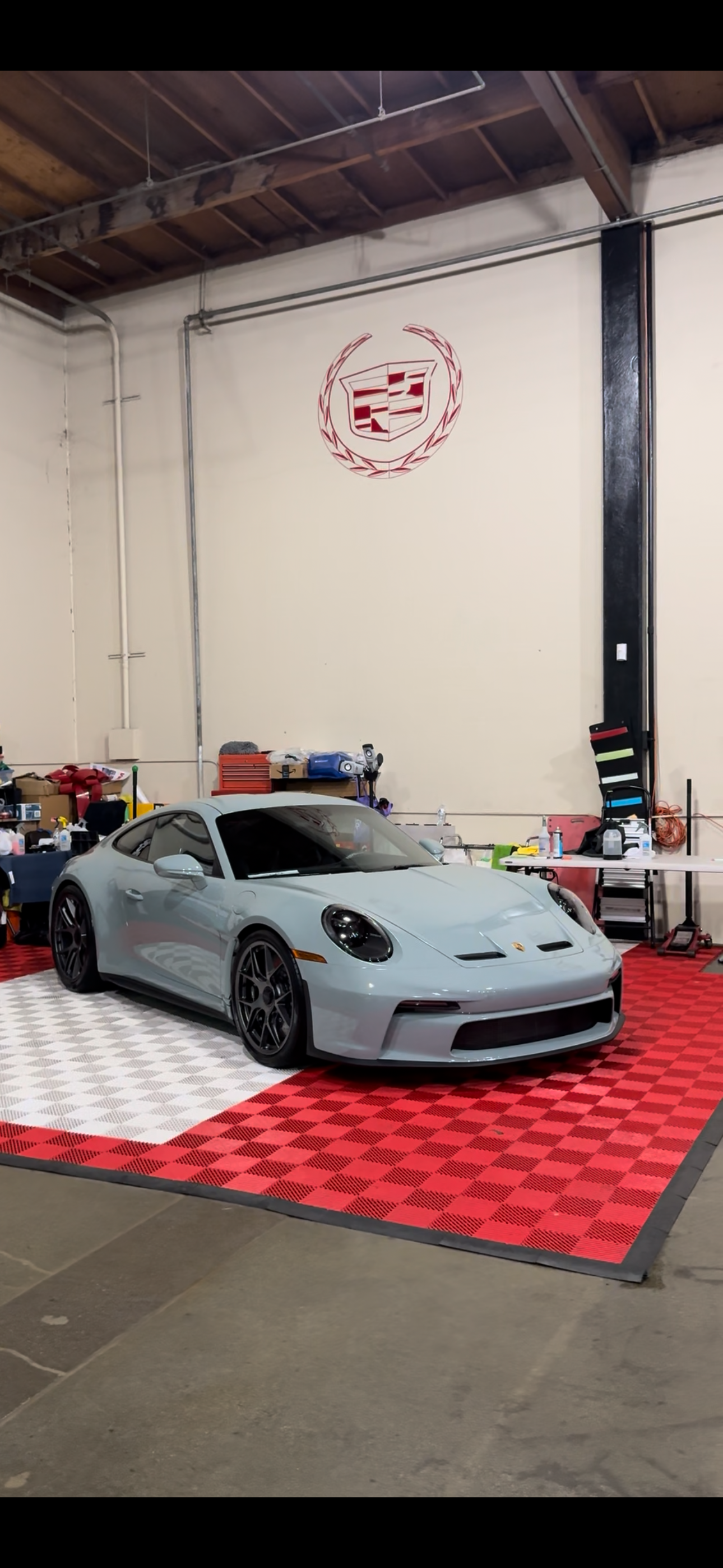 Light grey Porsche 911 GT3 on checkered floor
