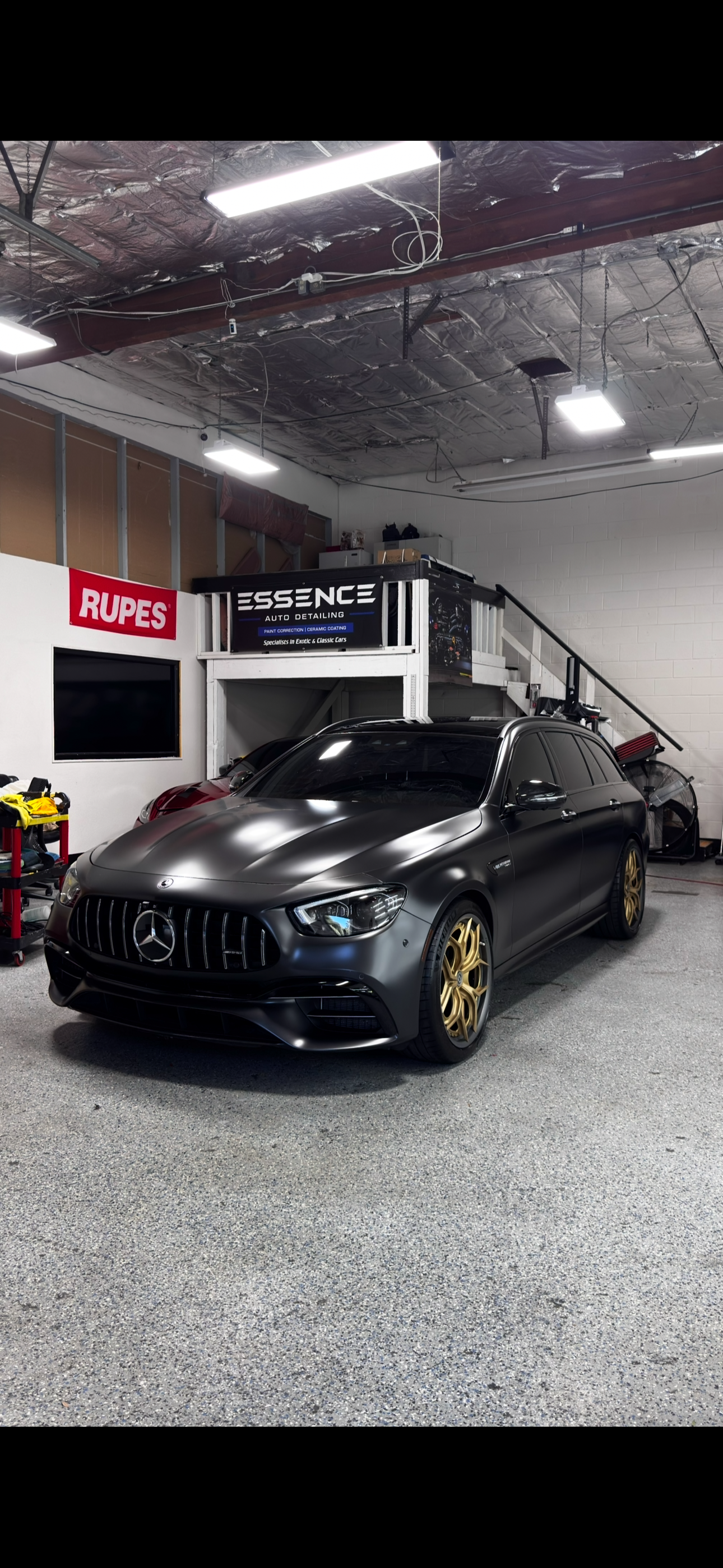 Matte black Mercedes-AMG wagon with gold wheels