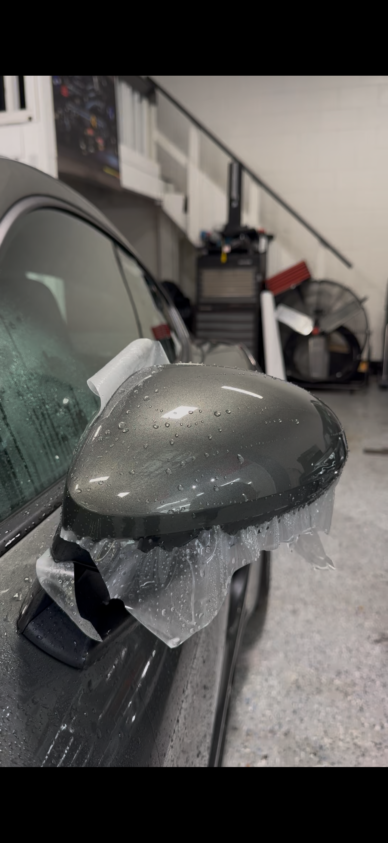 PPF film applied to a grey car side mirror