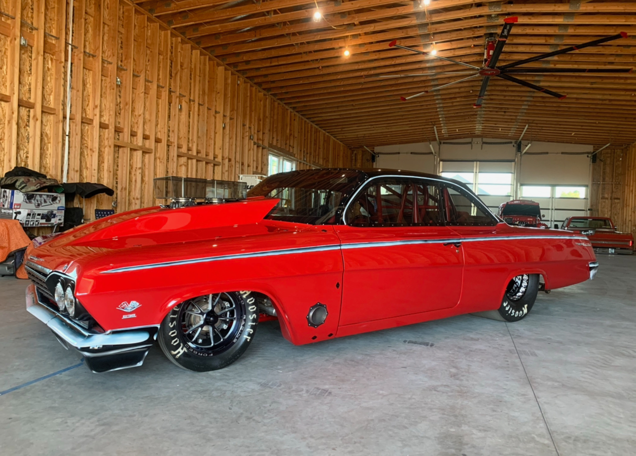 Red classic drag racing car in workshop