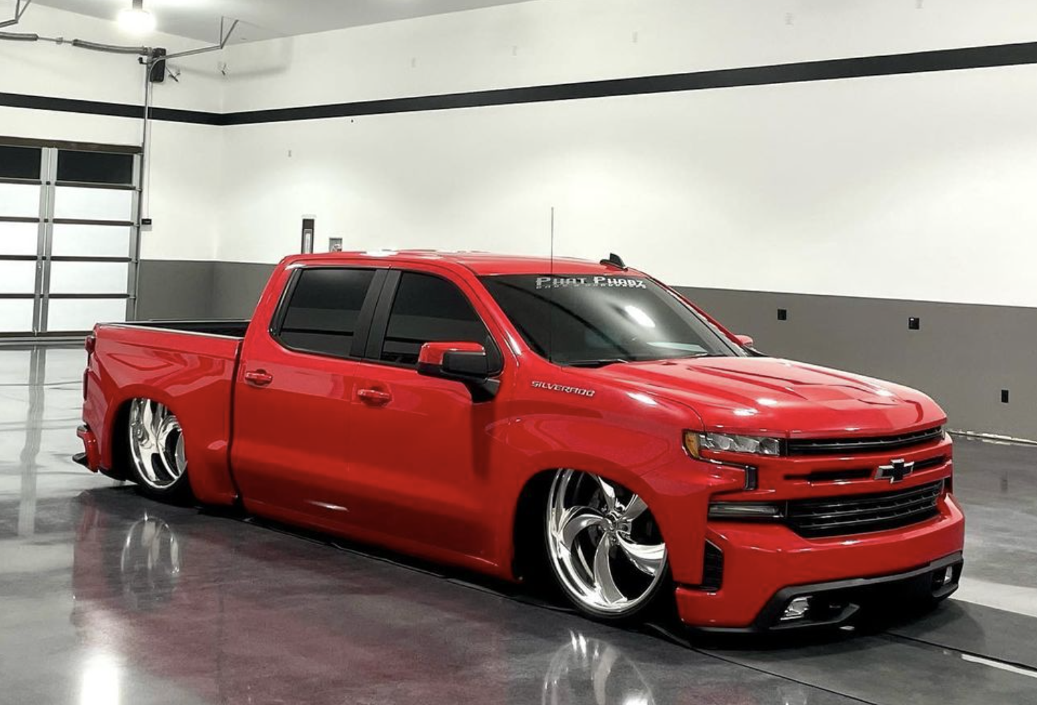 Lowered red Chevrolet Silverado in the Essence studio