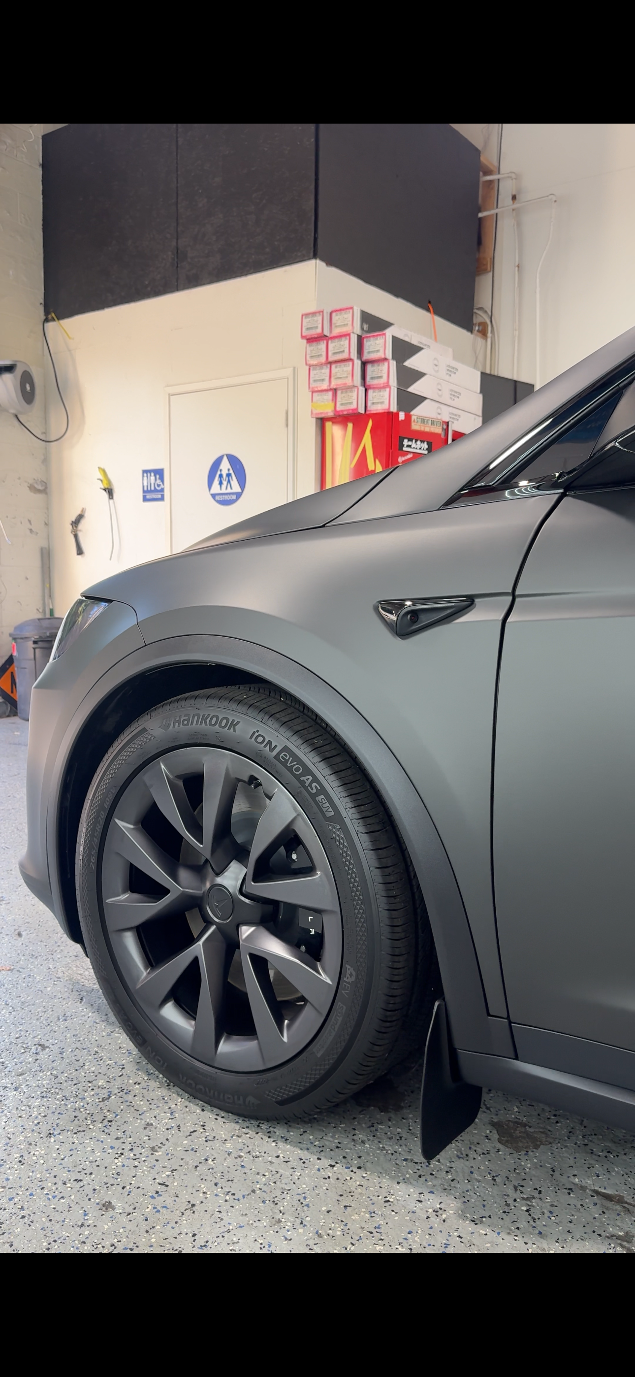 Matte grey Tesla wheel and fender detail shot