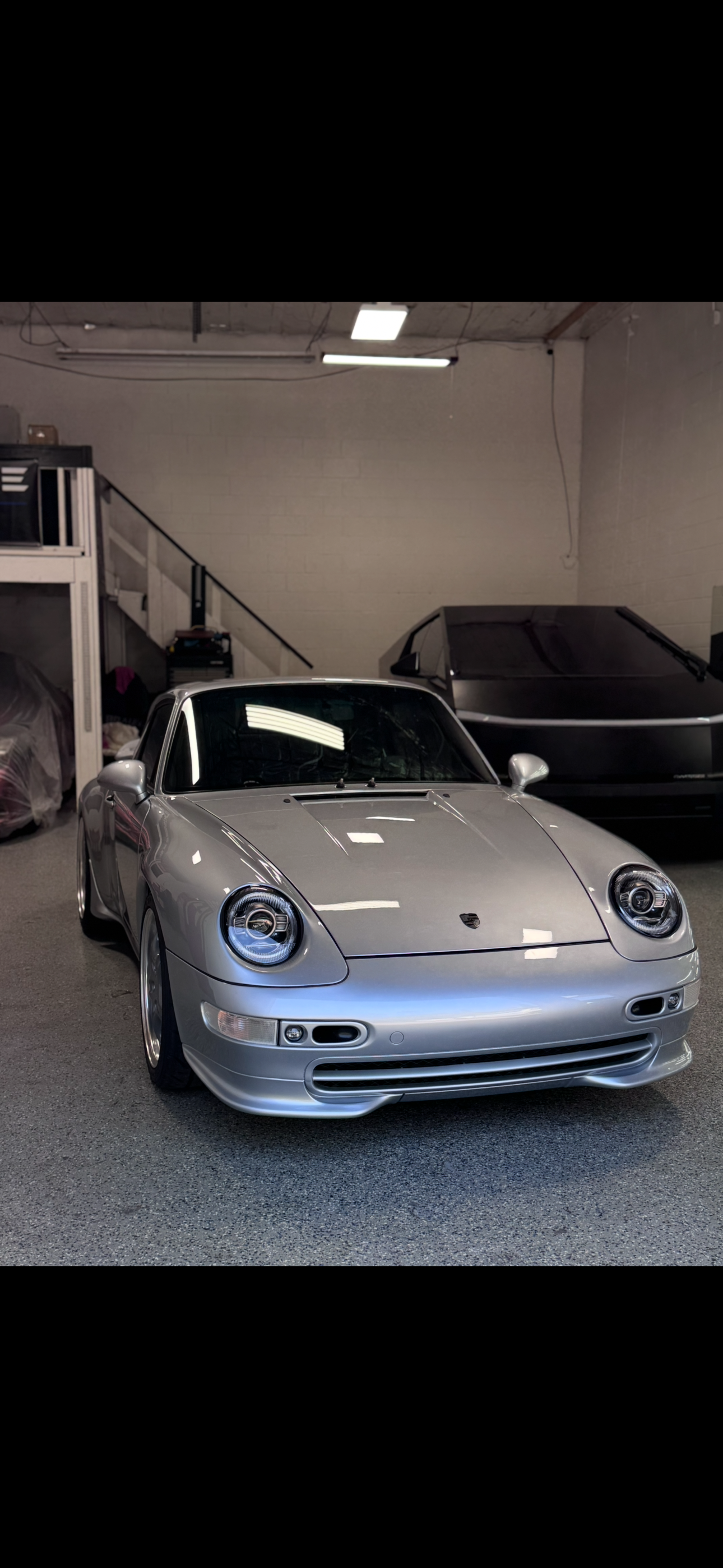 Silver Porsche 911 993 parked in the detailing shop