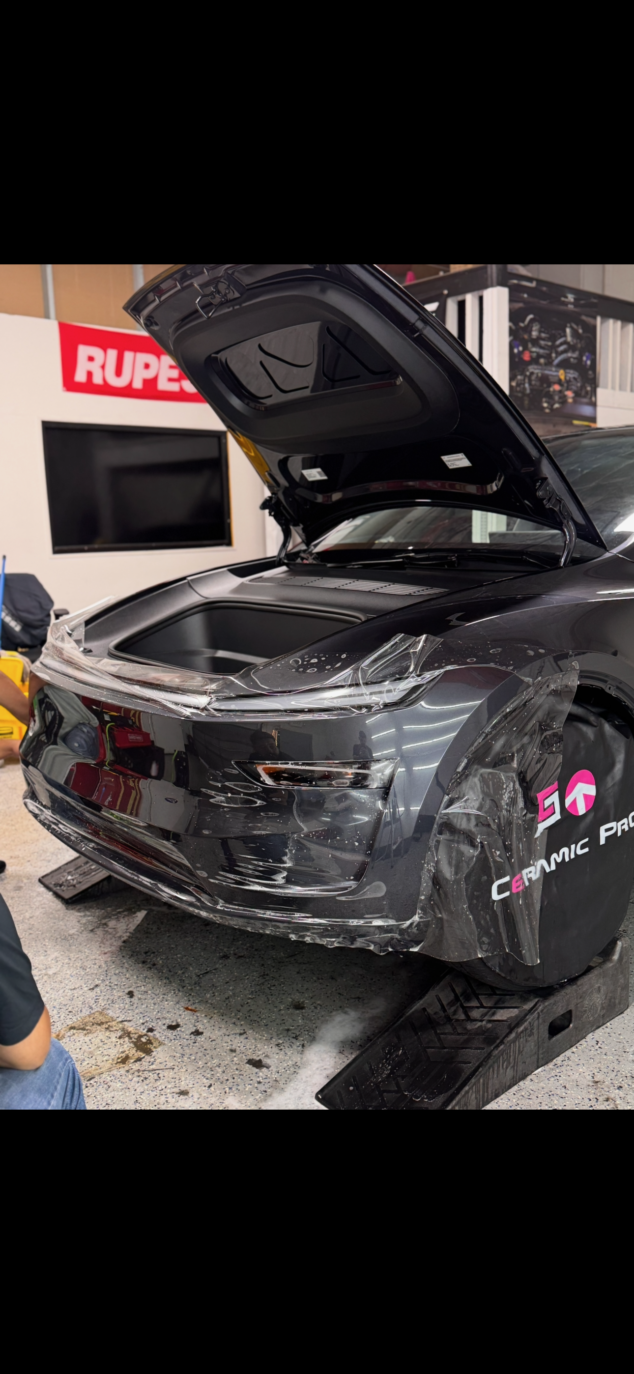 PPF installation on a black Tesla with frunk open