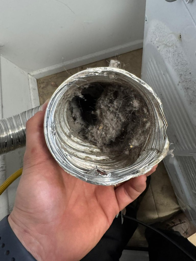 Dryer vent cleaning during a Summit Home Services service visit.