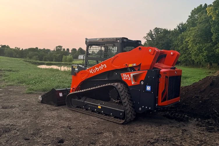 Triple M Excavation's Kubota track loader on a cleared Missouri job site at dusk