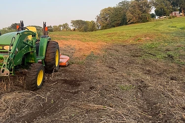 Rolling Missouri field with a freshly worked strip of ground being leveled by Triple M Excavation