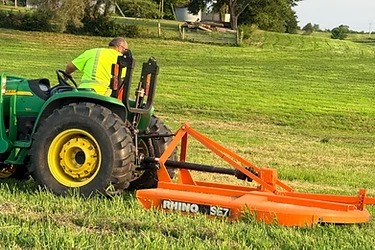 Mason brush hogging an overgrown Missouri field with a tractor and rotary cutter