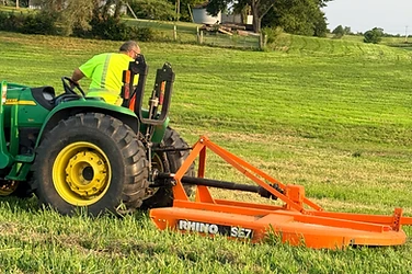 Mason brush hogging an overgrown Missouri field with a tractor and rotary cutter