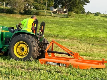 Mason brush hogging an overgrown Missouri field with a tractor and rotary cutter