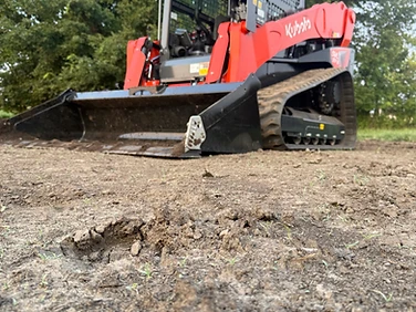 Grading and leveling bare dirt on a Northland build site