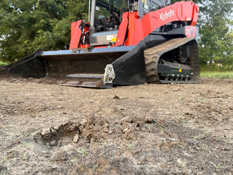 Triple M Excavation's Kubota track loader grading bare dirt on a Missouri property