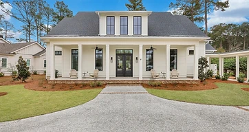 Dark shingle roof and a metal porch roof on a white two-story home