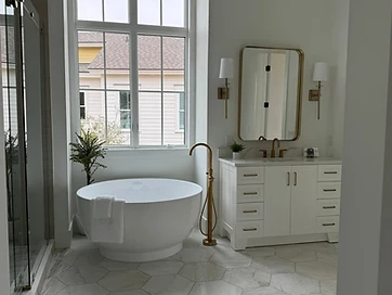 Primary bath with round soaking tub under tall window, brass tub filler, and hexagon marble floor