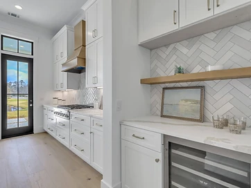 Kitchen counter with herringbone tile, a floating shelf, and a wine refrigerator