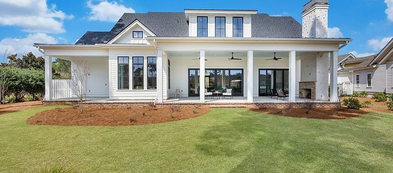 Finished custom home with covered rear porch and outdoor fireplace