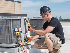 HVAC technician servicing an outdoor air conditioning unit