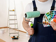 Painter rolling paint on an exterior wall