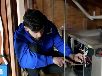 Pacific Air HVAC technician servicing a furnace control board in a New Jersey home